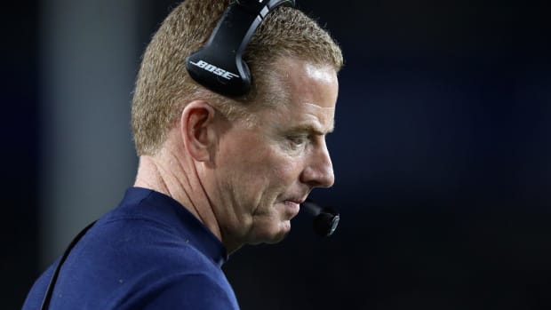 Jason Garrett stares down at the field during a game.