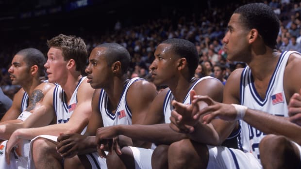 Jay Williams and the Duke basketball starters on the bench.