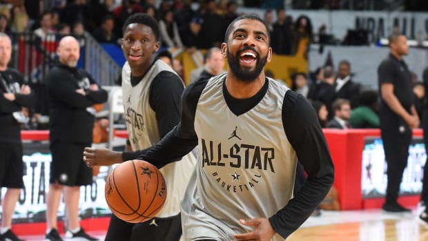 Kyrie Irving smiling during warmups for the NBA All-Star game.