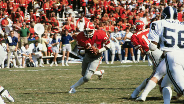 Georgia legend Herschel Walker runs the ball.
