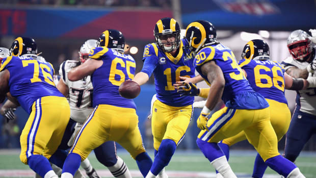 the los angeles rams rush the ball against the patriots