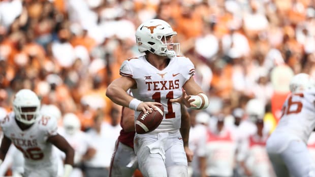 Sam Ehlinger of Texas attempts to throw a pass