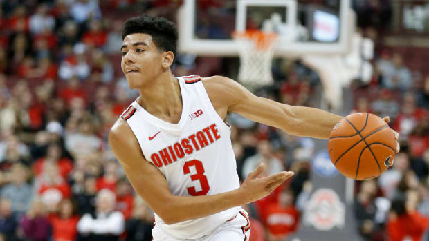 Ohio State point guard D.J. Carton throws a pass in a game.