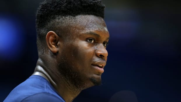 Former Duke star Zion Williamson warms up during an NBA game.
