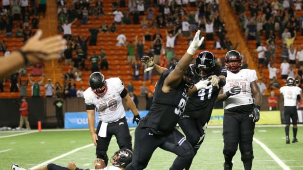 Late Hawaii linebacker Scheyenne Sanitoa celebrates a big play.