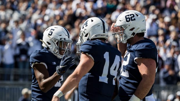 Penn State players including Michal Menet celebrate a touchdown.
