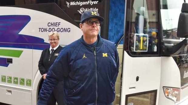 Jim Harbaugh walks off the bus before Michigan's game vs. Ohio State.