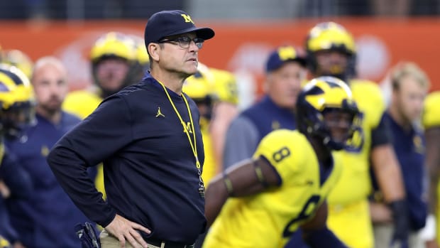 Head coach Jim Harbaugh of the Michigan Wolverines looks on during warmups before the college football game against the Florida Gators.