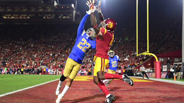 UCLA defender looks to break up a pass to USC wide receiver in the major Pac-12 football rivalry game.