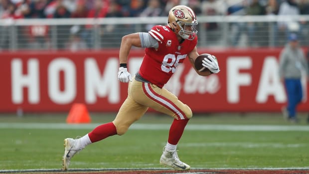 George Kittle running with the football.