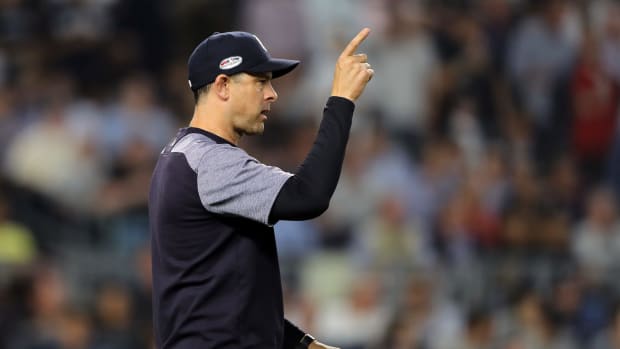 Aaron Boone points to make a pitching change during a game,