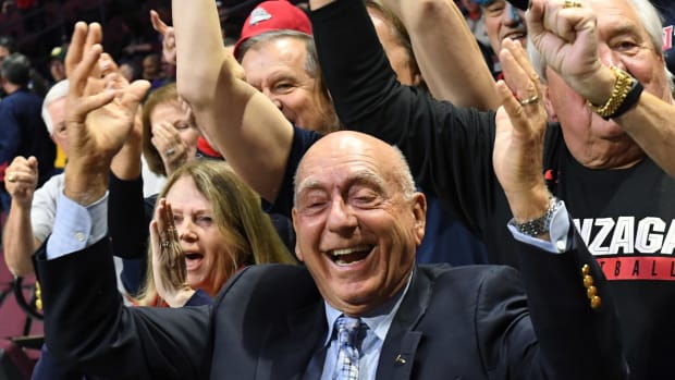 Dick Vitale celebrating with fans.