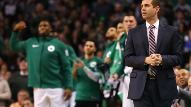 Brad Stevens clasping his hands on the Celtics bench.