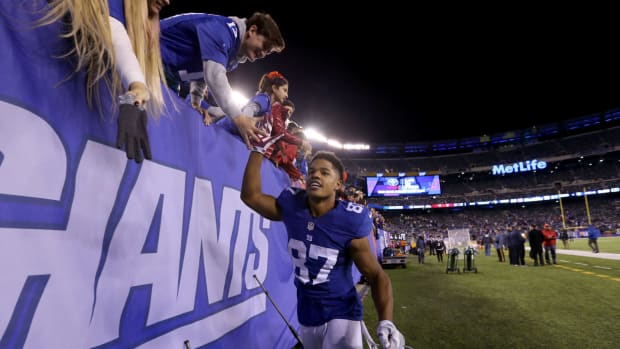 Sterling Shepard interacting with fans after a Giants game.