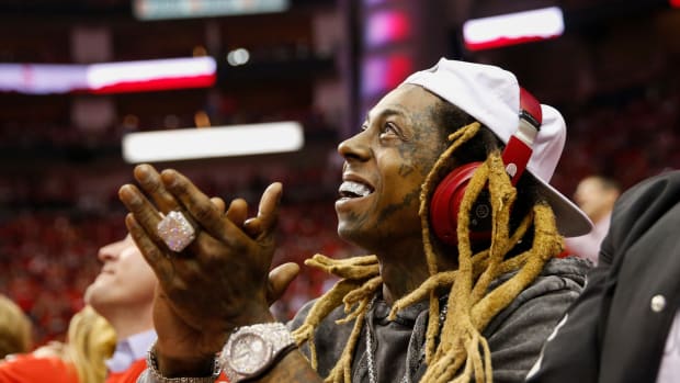 Lil Wayne attending a sporting event.
