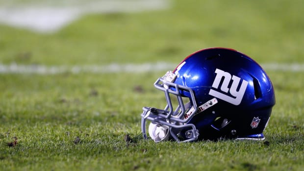A New York Giants helmet sitting on the field.