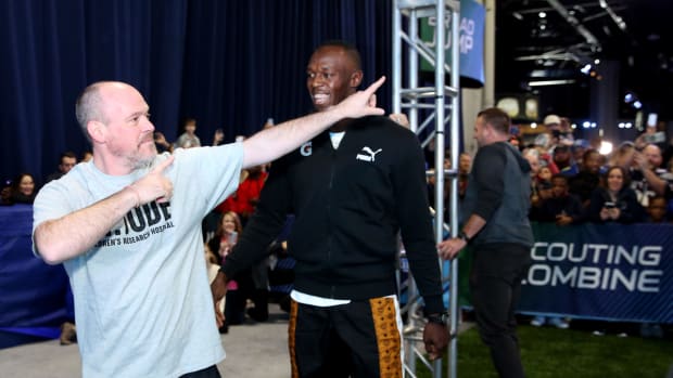 Rich Eisen and Usain Bolt joke around during a charity event.
