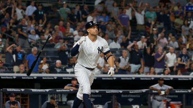 New York Yankees OF Giancarlo Stanton flipping his bat after hitting a home run.