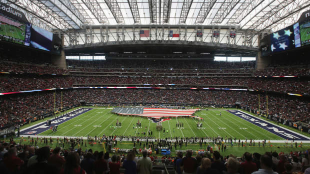 A view of the Texans stadium with an American flag on the field.