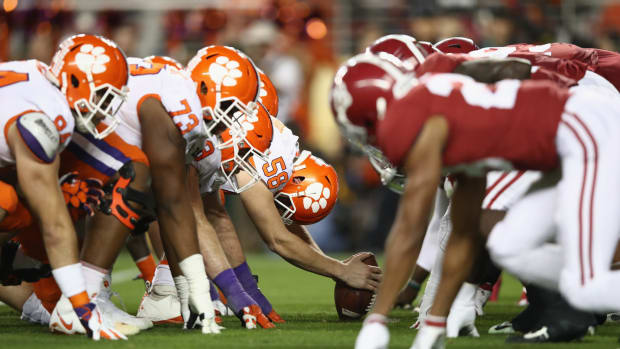 Alabama and Clemson players lining up for a snap.