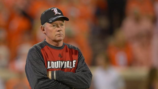 Bobby Petrino with his arms folded ahead of a Louisville game.