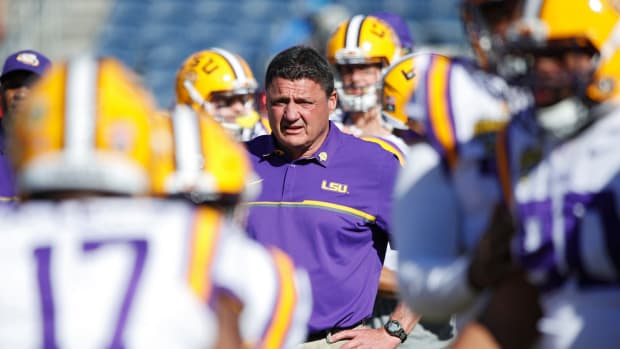 Ed Orgeron watches his LSU Tigers warm up before the Citrus Bowl.