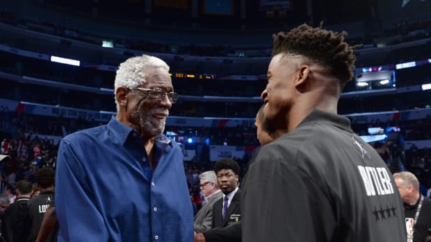 NBA legend Bill Russell talks with Jimmy Butler at the All-Star Game.