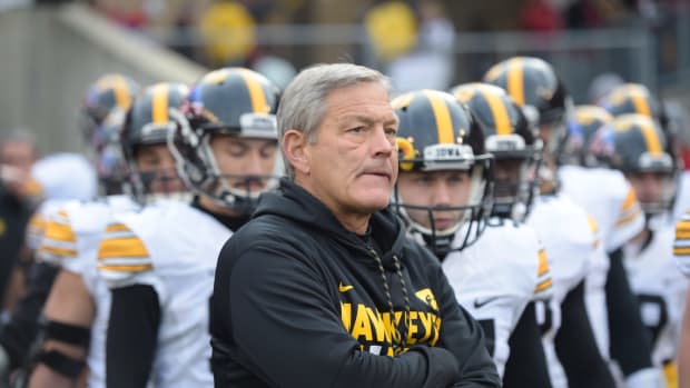 Kirk Ferentz waits with his team before game.