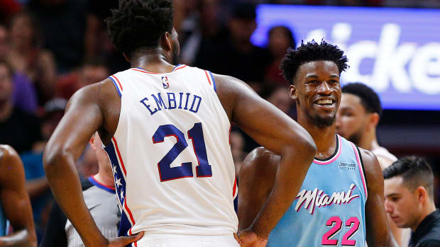 Jimmy Butler and Joel Embiid interact during a game.