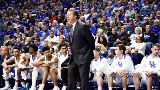 Coach Cal with his hands behind his back on the Kentucky sideline.