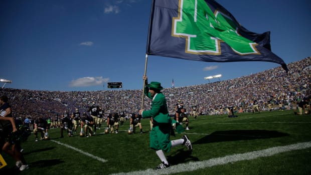 Notre Dame's mascot running with a flag.