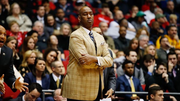 Danny Manning with his arms crossed on the sideline.