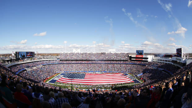 A general view of the Buffalo Bills stadium with an American flag stretched across the field.