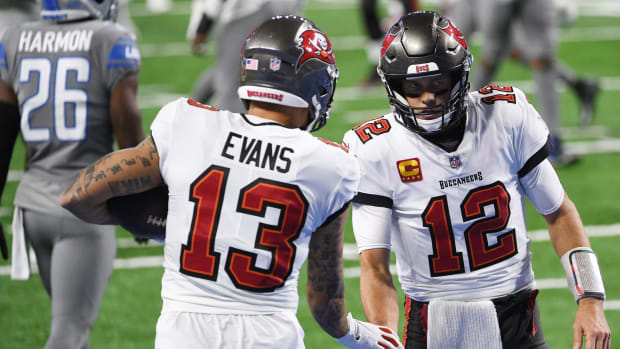 Tampa Bay Buccaneers wide receiver Mike Evans and quarterback Tom Brady shake hands.