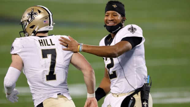 Jameis Winston and Taysom Hill celebrating a New Orleans Saints play.