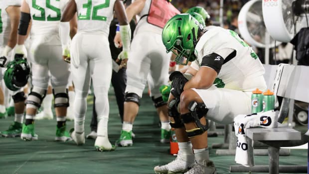 Oregon football star Penei Sewell on the bench during a Pac-12 game vs. Arizona State.