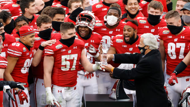 Wisconsin players receiving a trophy for winning the Duke's Mayo Bowl.