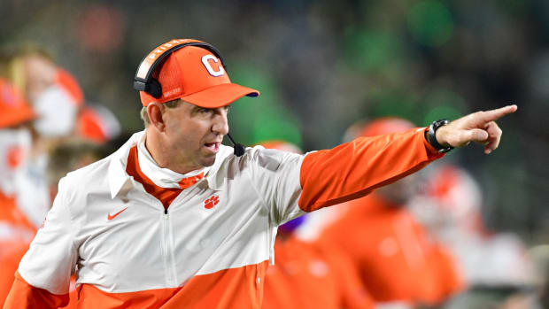 Head coach Dabo Swinney of the Clemson Tigers signals to his players