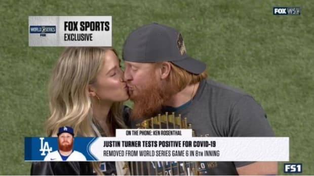 Justin Turner celebrates the Los Angeles Dodgers World Series with his wife after leaving the game due to a positive test.