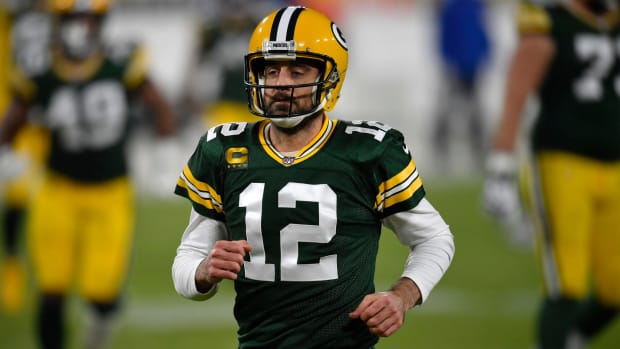 Quarterback Aaron Rodgers #12 of the Green Bay Packers warms up prior to the game against the Carolina Panthers