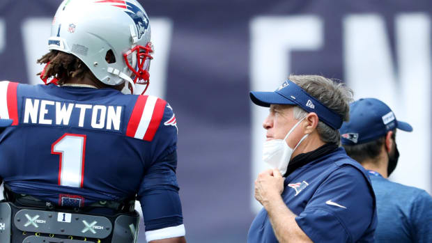 Cam Newton and Bill Belichick speak on the sideline during a New England Patriots game.