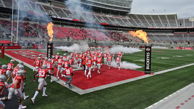 Ohio State players run onto the field before a game in September.