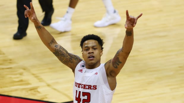 Jacob Young on the court celebrating a win for Rutgers basketball.