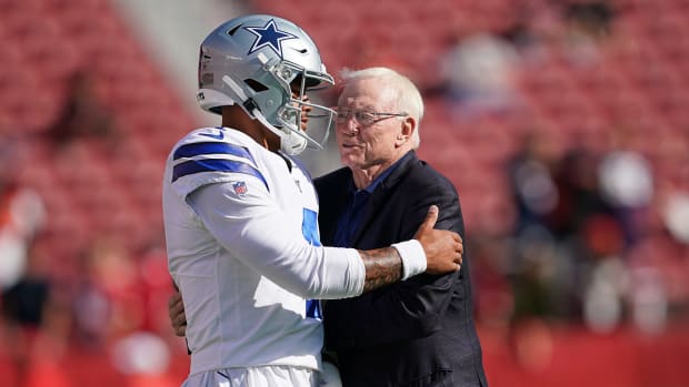 Dak Prescott and Jerry Jones embrace before a Dallas Cowboys game.