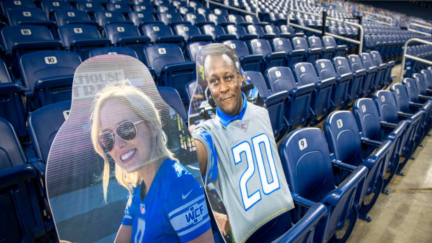 Cutouts of Matthew Stafford's wife Kelly Stafford and Barry Sanders at a Detroit Lions game.