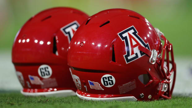 Two Arizona Wildcats football helmets.