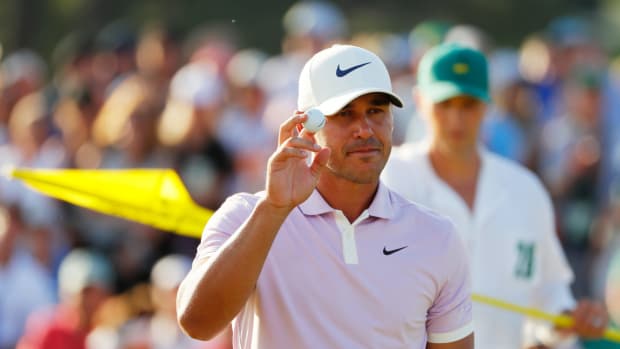 Brooks Koepka acknowledges patrons after putting on the 18th green.
