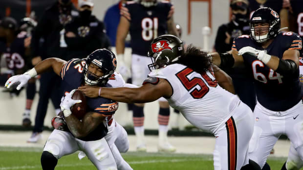 Tampa Bay Buccaneers defensive tackle Vita Vea makes a tackle against the Chicago Bears running back David Montgomery during a game.