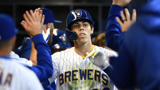 Christian Yelich celebrating in the dugout.