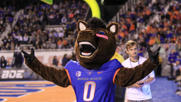 Boise State's mascot raising its arms.